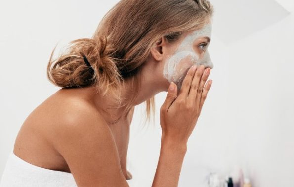 Woman appplying cosmetic mask