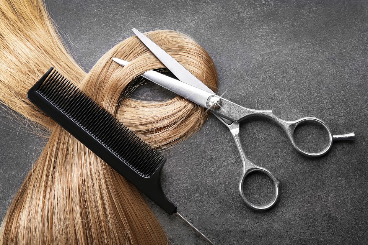 Hairdresser's scissors with comb and strand of blonde hair