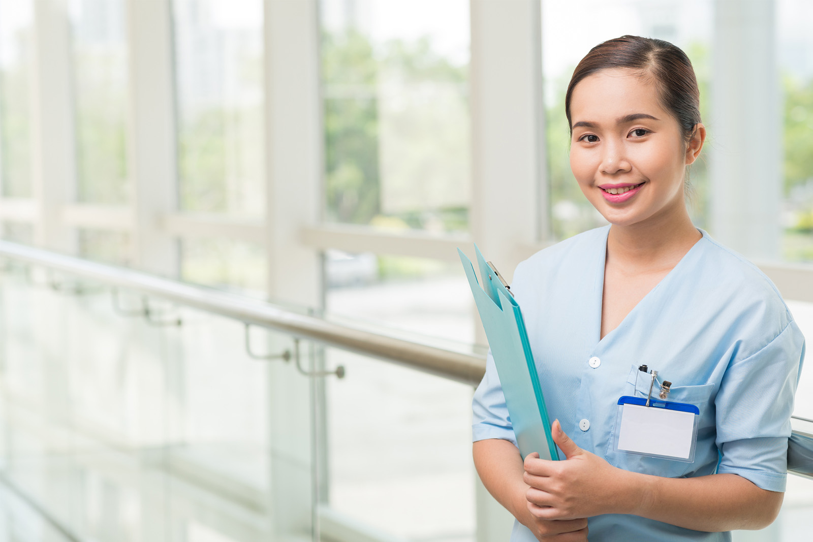 Medical assistant holding clipboard